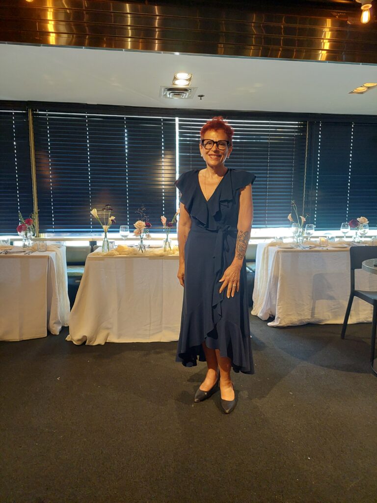 
wedding officiant, Sandra Ruch standing in front of head table at wedding in 2024.